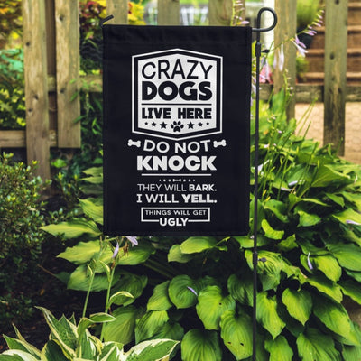 black garden flag with text "crazy dogs live here do not knock they will bark, i will yell, things will get ugly"