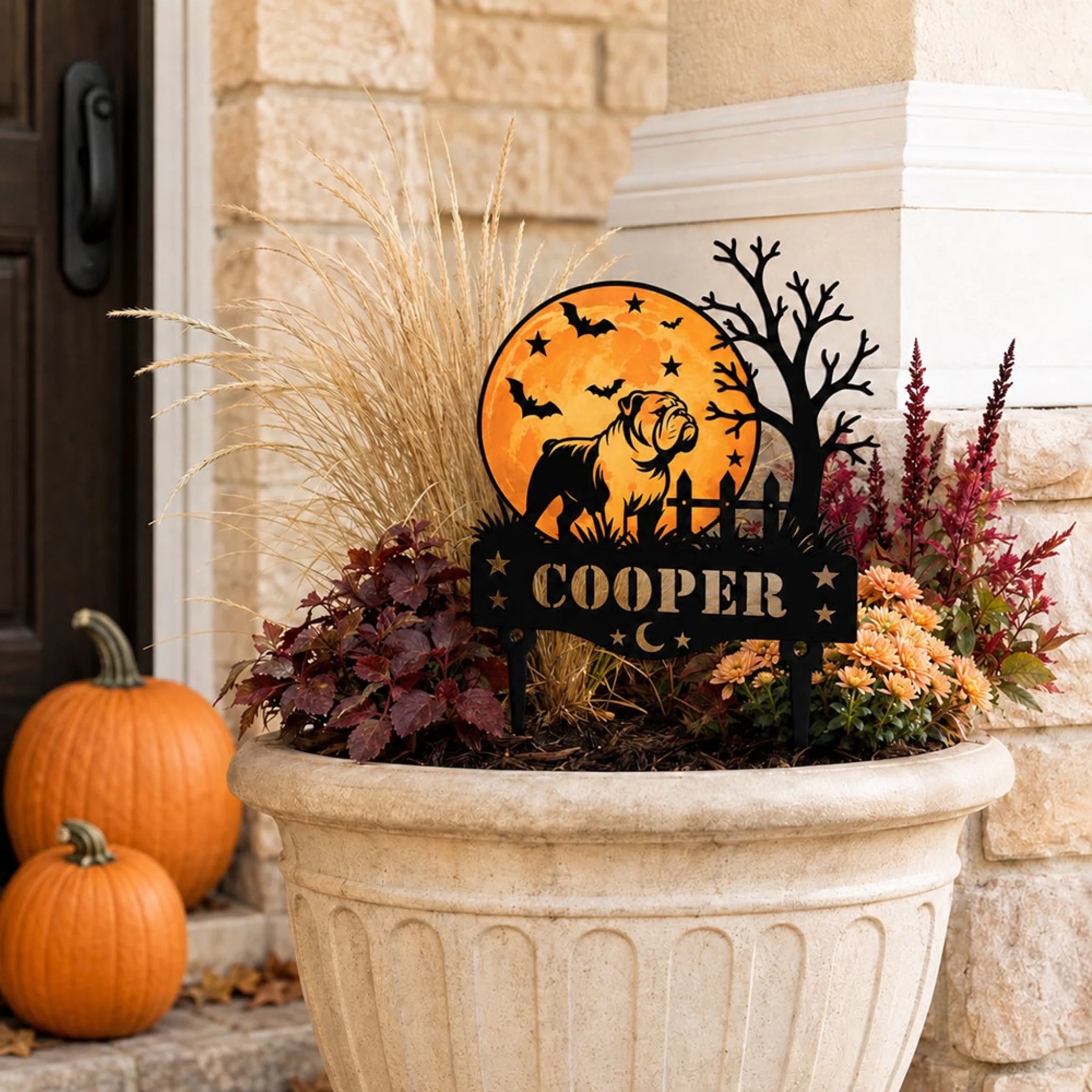Personalized Halloween dog garden stake displayed in an autumn porch planter with pumpkins