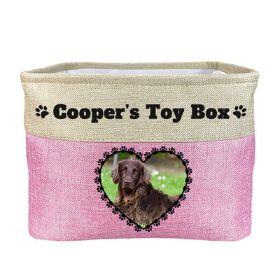 Pink toy box with text "Cooper's toy box", image of dog in heart-shaped frame on toy box