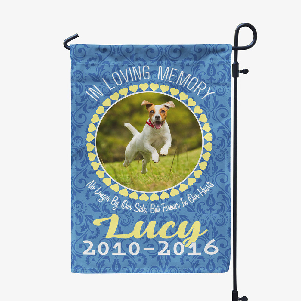 blue garden flag with text "in loving memory, no longer by our side, but forever in our hearts, Lucy two thousand ten to two thousand sixteen" with image of dog in circular frame