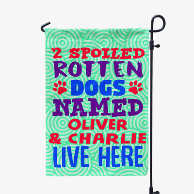 green garden flag with text "two spoiled rotten dogs named oliver and charlie live here"