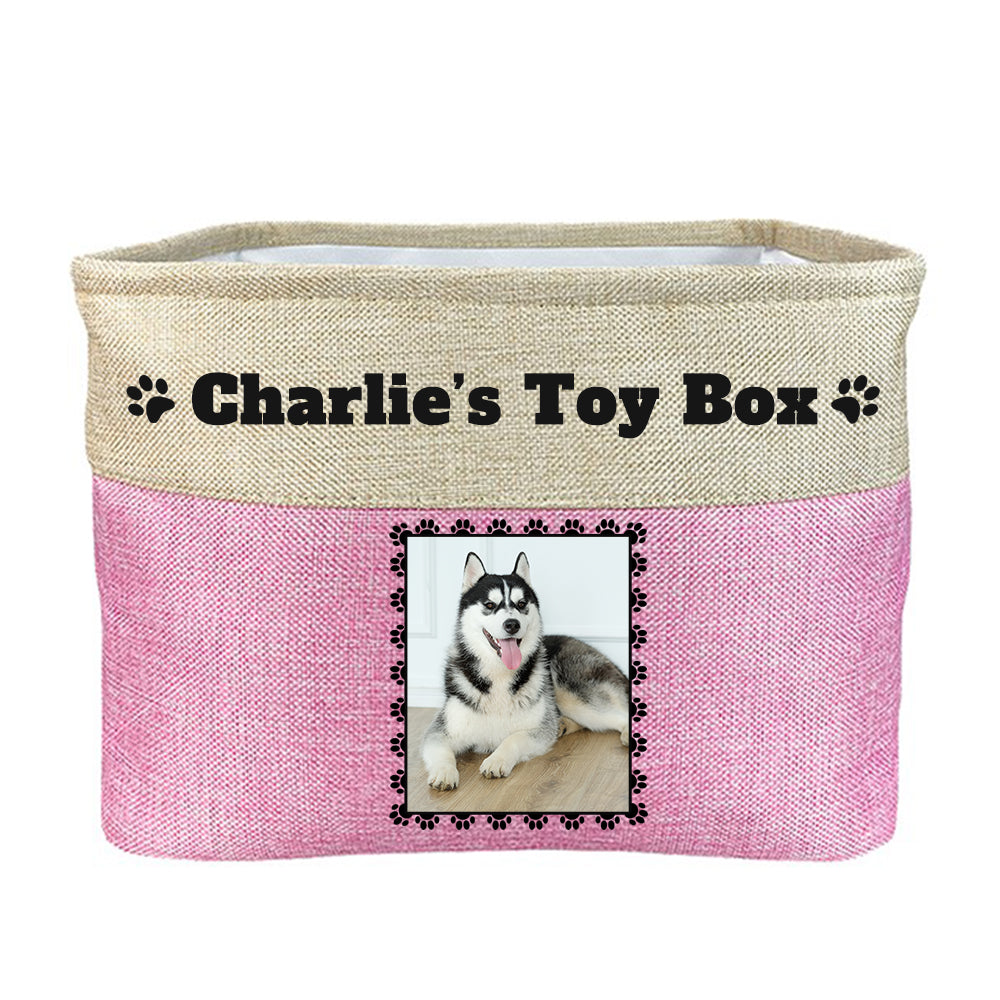 Pink toy box with text "Charlie's toy box", image of dog in rectangular frame on toy box