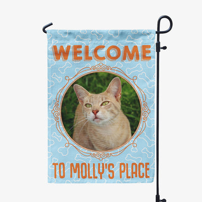 blue garden flag with text "welcome to molly's place" with image of cat in circular frame