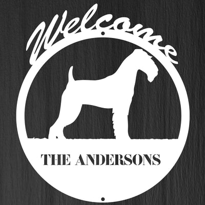 circular dog themed metal sign with text "welcome, the andersons"