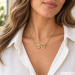 Illustrated close wearing view of a connected retriever and tabby necklace on a fine gold-colored chain. Actual fit varies.