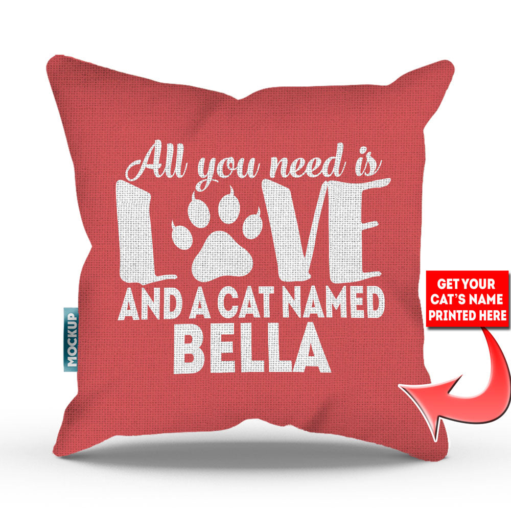 pink colored pillow with text "all you need is love and a cat named bella"