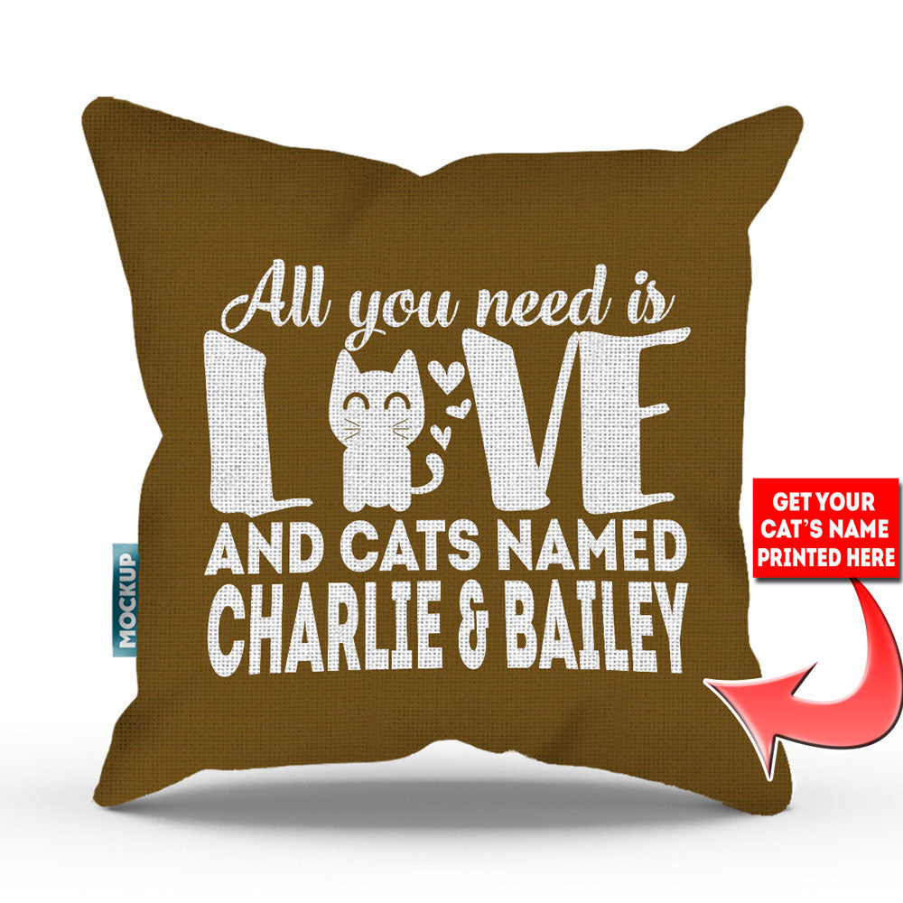 golden brown colored pillow with text "all you need is love and cats named charlie and bailey"