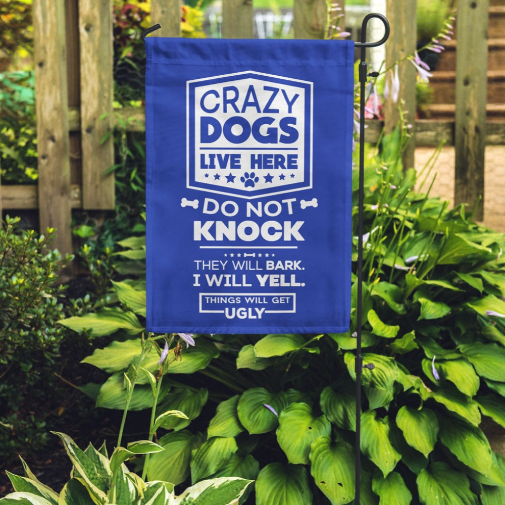 blue garden flag with text "crazy dogs live here do not knock they will bark, i will yell, things will get ugly"