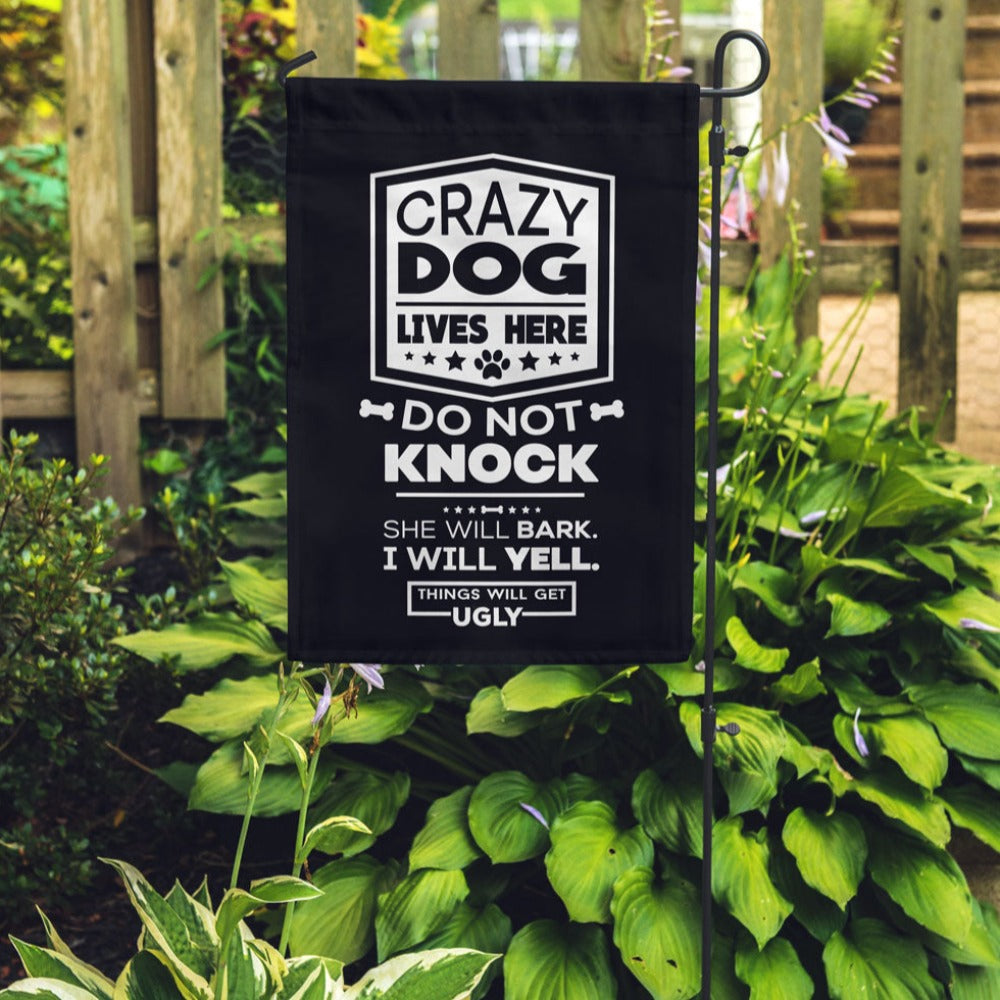 black garden flag with text "crazy dog lives here, do not knock, she will bark, i will yell, things will get ugly"