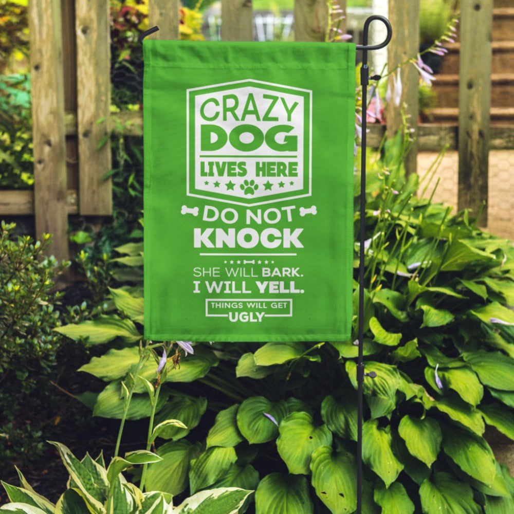 green garden flag with text "crazy dog lives here, do not knock, she will bark, i will yell, things will get ugly"